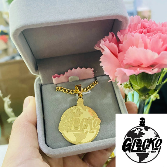 Custom cartoon character name necklace in a luxurious gift box, featuring a gold pendant and floral background.