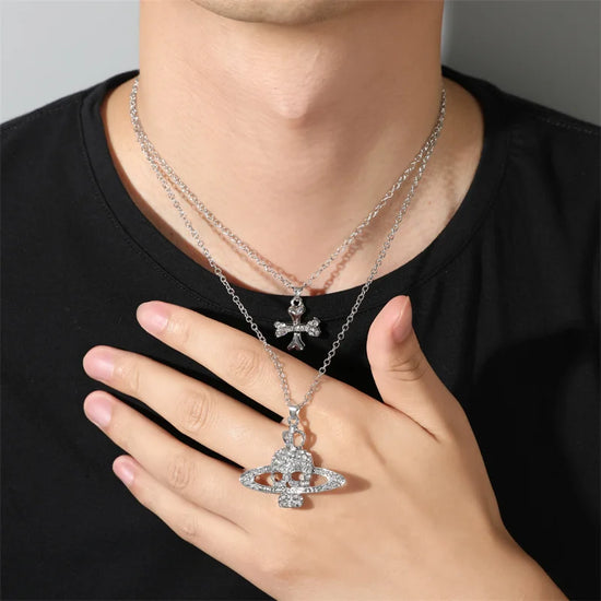 Gothic skull pendant necklace featuring rhinestone inlaid Saturn design on a double chain worn by a model.