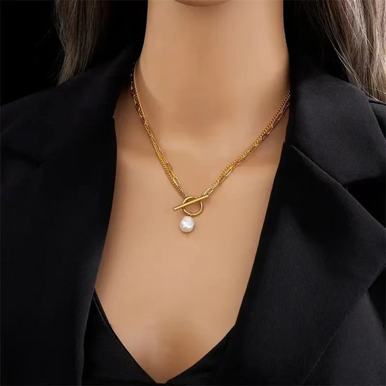 Alt Tag: big pearl pendant necklace for women gold chain with single pearl drop pendant worn on model neck close-up