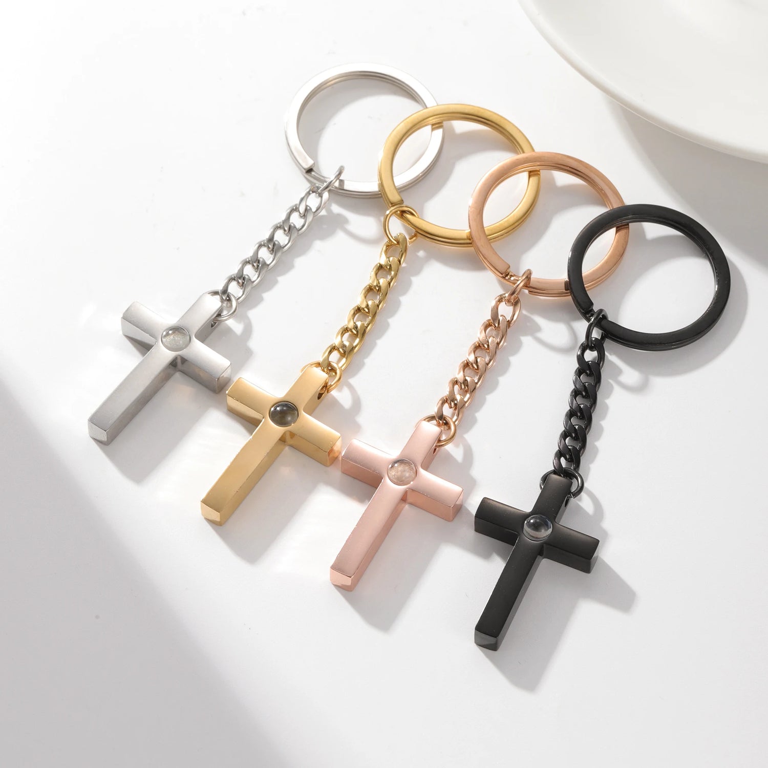 Custom cross projection necklace for men featuring four cross designs in silver, gold, rose gold, and black.