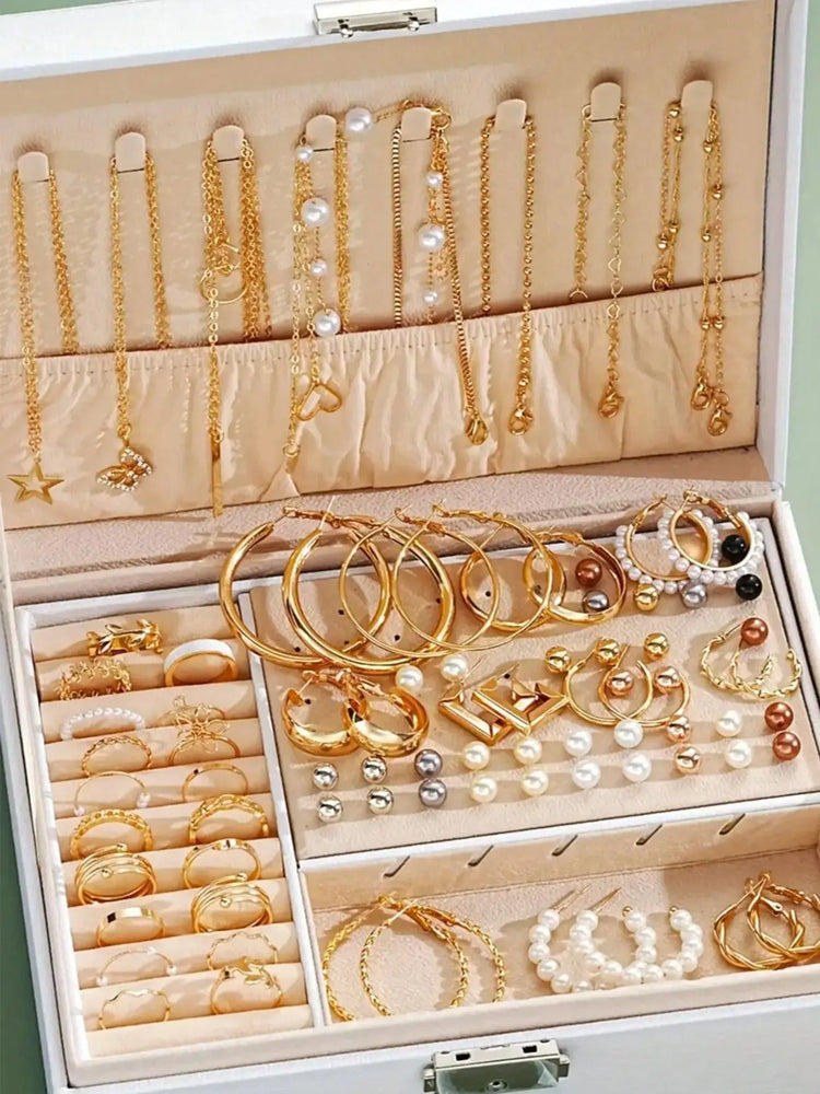 Alt Tag: elegant pearl jewelry set for women displayed in jewelry box with gold necklaces, hoop earrings, pearl bracelets and rings
