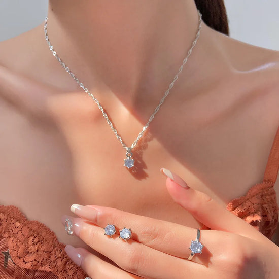 Alt Tag: 5 piece crystal jewelry set for women necklace, crystal pendant and matching rings on model close-up