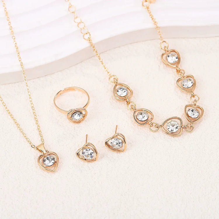 Alt Tag: heart crystal jewelry set for women gold necklace bracelet ring and stud earrings with clear heart crystals