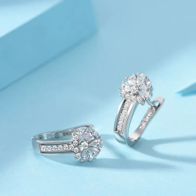 925 sterling silver zircon flower earrings with sparkling clear zircon stones, elegant flower cluster design on light blue background
