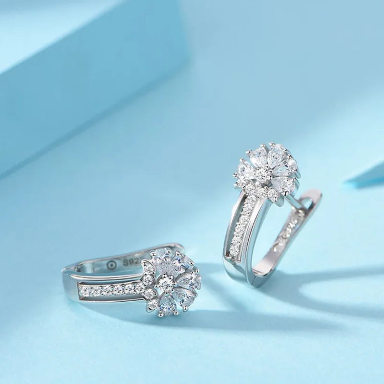 925 sterling silver zircon flower earrings with sparkling clear zircon stones, elegant flower cluster design on light blue background