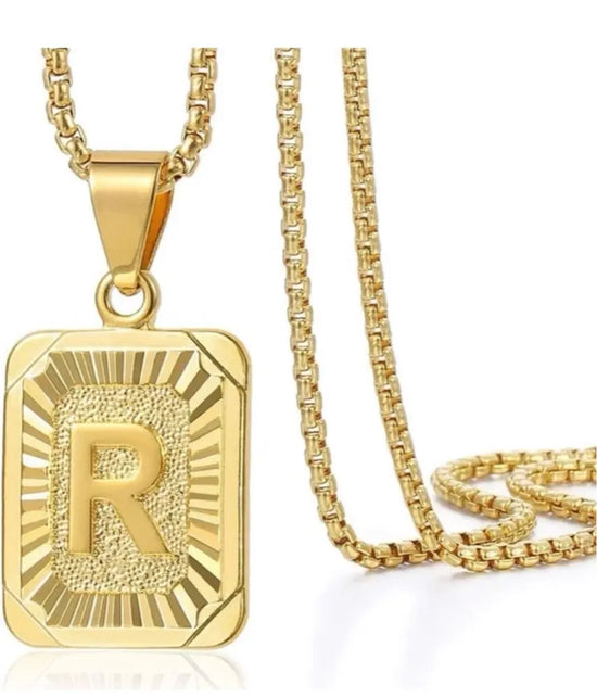 gold initial letter necklace featuring a gold square alphabet charm with &
