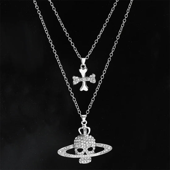 Gothic skull pendant necklace with rhinestones, featuring a double chain design and a cross charm.