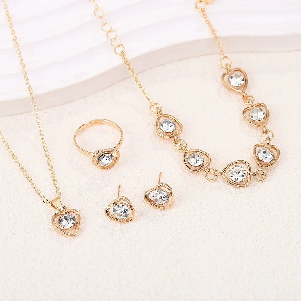 Alt Tag: heart crystal jewelry set for women gold-tone necklace bracelet ring and stud earrings with clear crystal heart charms