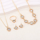 Alt Tag: heart crystal jewelry set for women gold-tone necklace bracelet ring and stud earrings with clear crystal heart charms
