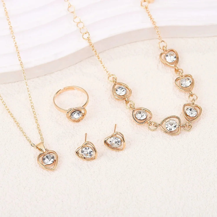 Alt Tag: heart crystal jewelry set for women gold-tone necklace bracelet ring and stud earrings with clear crystal heart charms
