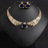 Alt Tag: bridal necklace and earrings set with gold-tone crystal collar necklace and blue oval stones, matching stud earrings on display bust