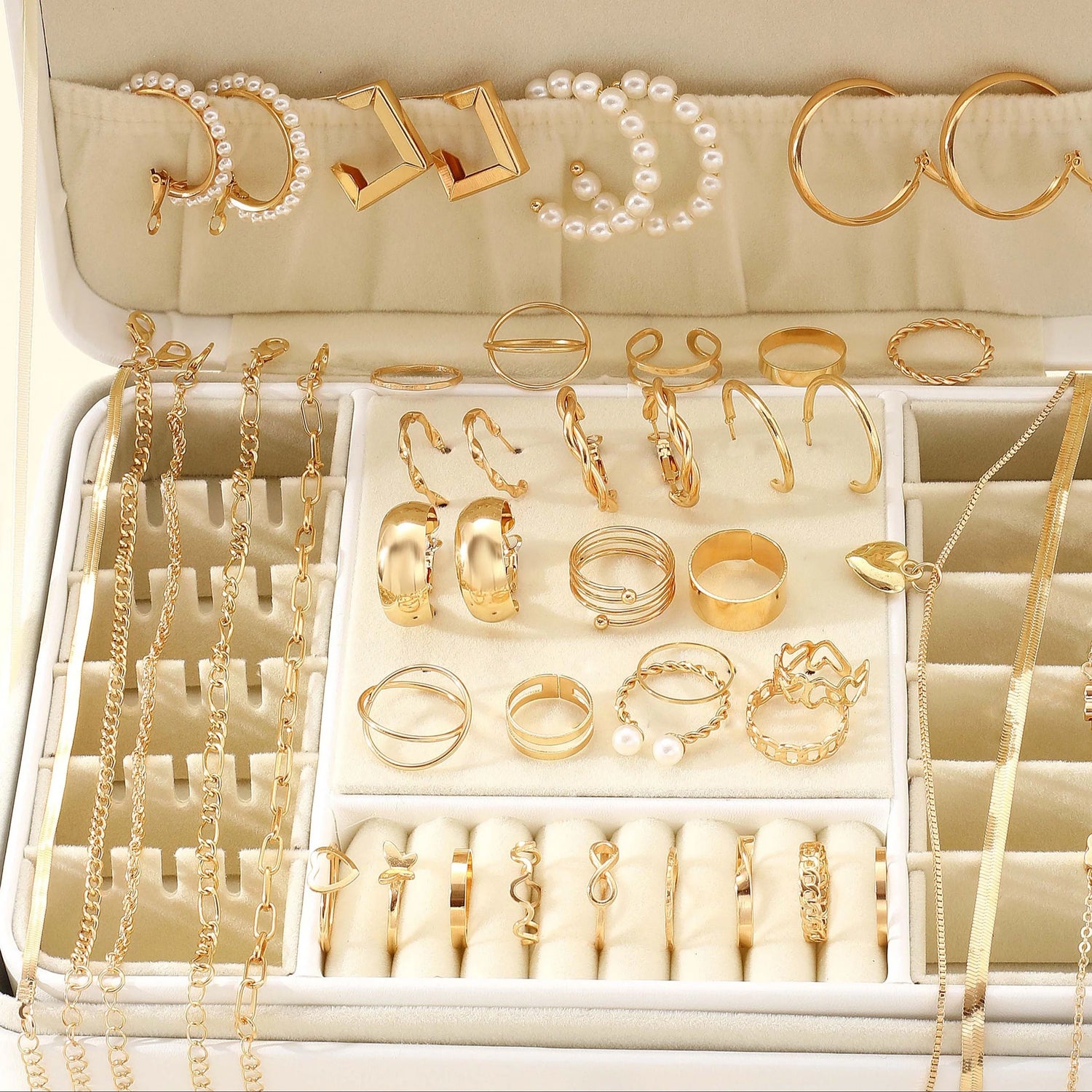 Alt Tag: 54 piece fashion jewelry set with gold-tone rings, hoop earrings, pearl accents and chain necklaces displayed in a jewelry organizer