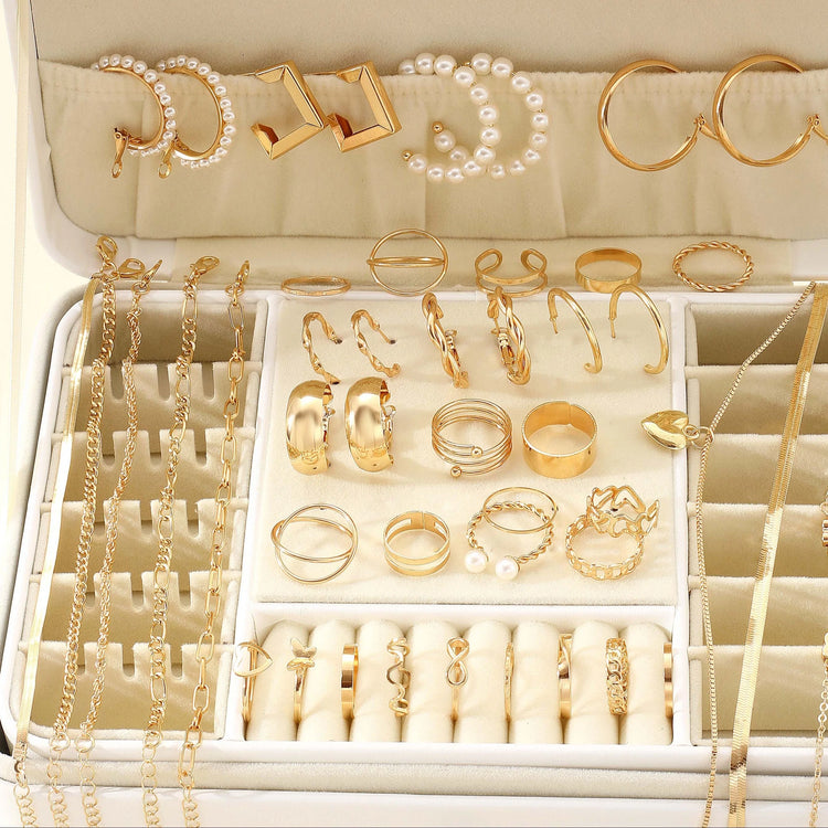 Alt Tag: 54 piece fashion jewelry set with gold-tone rings, hoop earrings, pearl accents and chain necklaces displayed in a jewelry organizer