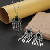 silver plated turquoise indian jewelry set necklace and earrings with ornate tribal silver design and dangling charms