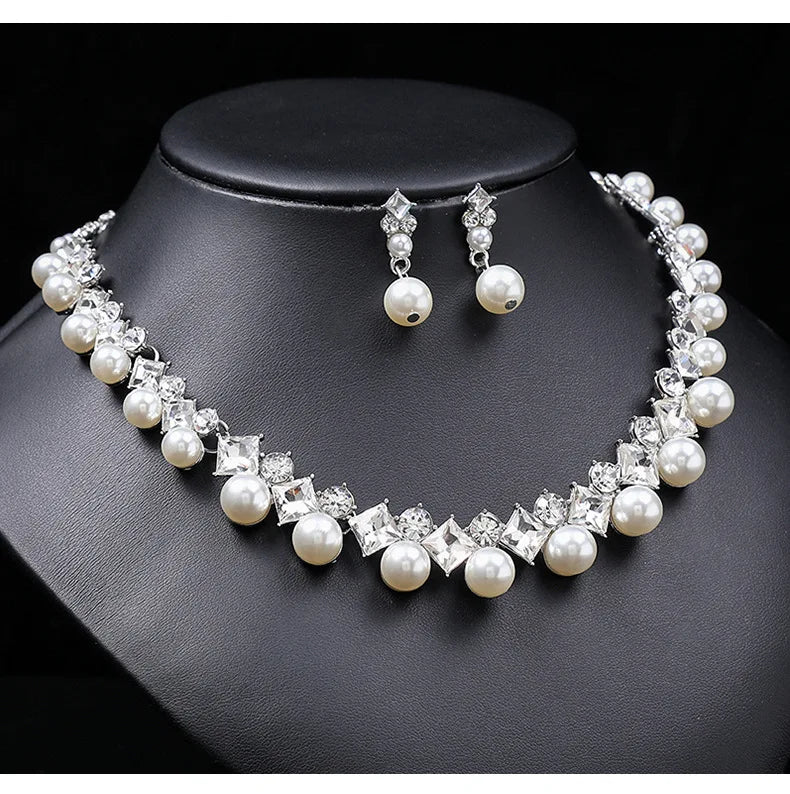 Alt Tag: pearl necklace and earrings set for women with white pearls and crystal rhinestones, necklace and drop earrings on black display bust