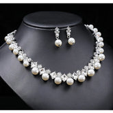 Alt Tag: pearl necklace and earrings set for women with white pearls and crystal rhinestones, necklace and drop earrings on black display bust