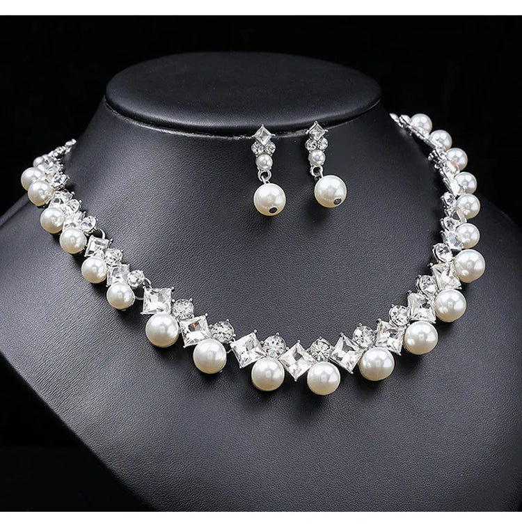 Alt Tag: pearl necklace and earrings set for women with white pearls and crystal rhinestones, necklace and drop earrings on black display bust