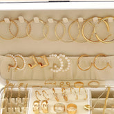 Alt Tag: 54 piece fashion jewelry set with gold hoop earrings, pearl hoops, rings, and chain bracelets in organized display case