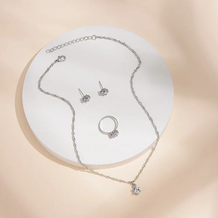 Alt Tag: 5 piece crystal jewelry set for women silver tone necklace with crystal pendant, stud earrings and ring on display