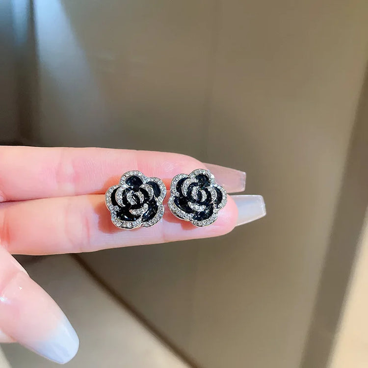 crystal flower rhinestone choker necklace set black rose crystal flower stud earrings close-up on hand