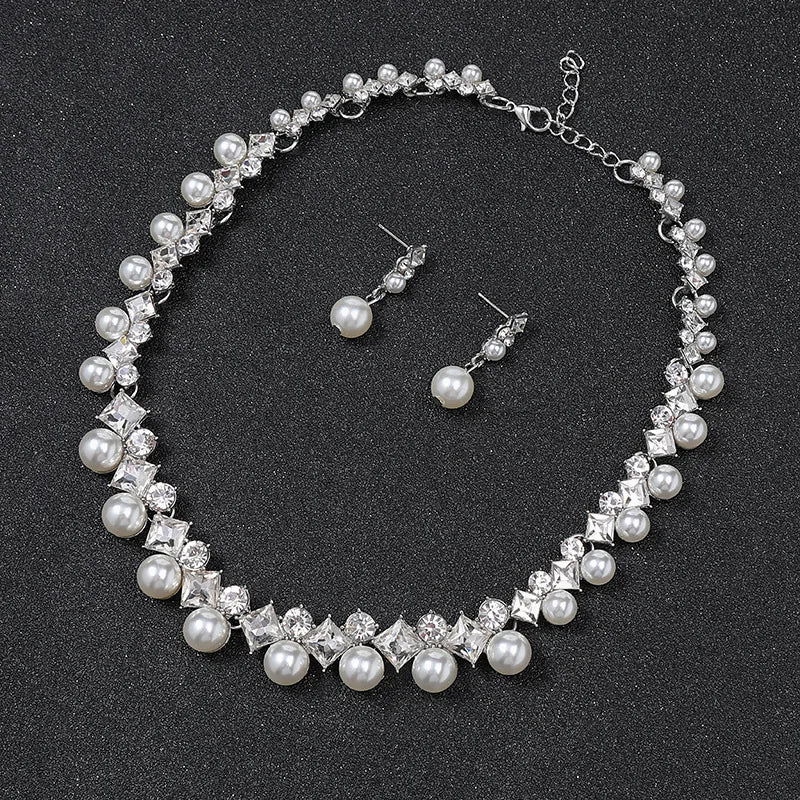 Alt Tag: pearl necklace and earrings set for women with crystal rhinestone choker and matching pearl drop stud earrings on black background