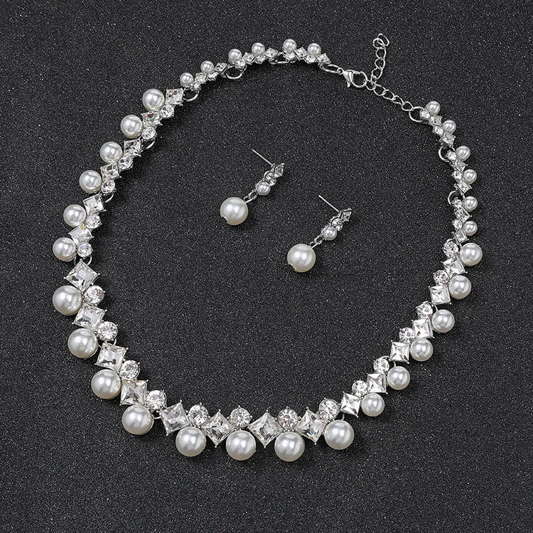 Alt Tag: pearl necklace and earrings set for women with crystal rhinestone choker and matching pearl drop stud earrings on black background