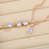 Alt Tag: 5 piece crystal jewelry set for women rose gold necklace and ring with clear crystal stones on display