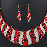 crystal bridal necklace and earrings set with red crystals and rhinestones, elegant wedding jewelry set on black background