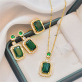 Alt Tag: emerald green zircon wedding jewelry set gold-tone necklace and drop earrings with rectangular green stones and crystal halo