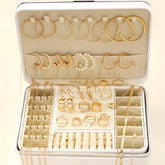 Alt Tag: 54 piece fashion jewelry set with gold-tone hoop earrings, rings, and chains organized in a travel jewelry box