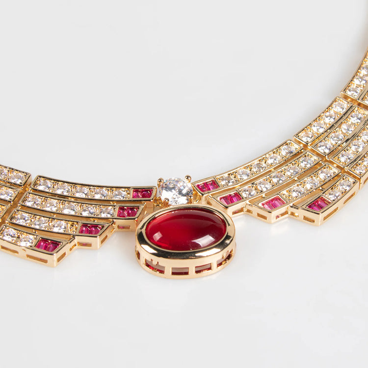 Alt Tag: bridal necklace and earrings set gold-tone crystal necklace with red gemstone pendant, close-up detail