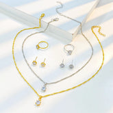 Alt Tag: 5 piece crystal jewelry set for women with necklaces, rings, and crystal stud earrings in gold and silver tone