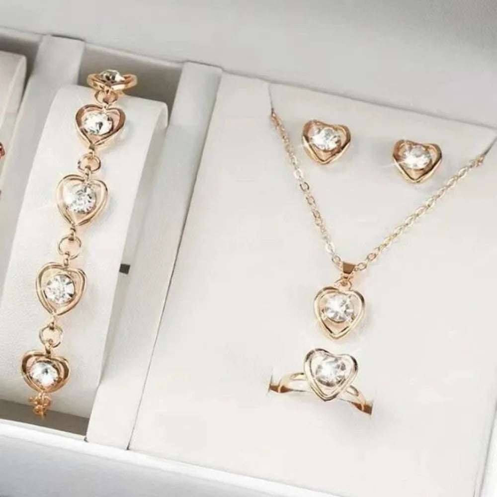 Alt Tag: heart crystal jewelry set for women with gold-tone heart crystal necklace, bracelet, earrings, and ring in gift box