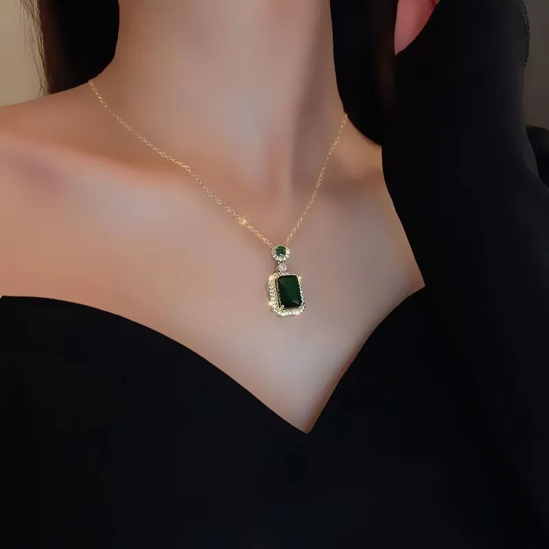 Alt Tag: titanium steel green zircon necklace for women on model, gold chain with emerald green rectangular pendant and halo setting