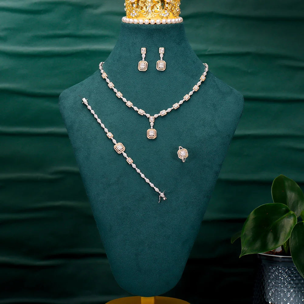 Alt Tag: rhinestone crystal bridal jewelry set with necklace, earrings, bracelet and ring displayed on green velvet bust