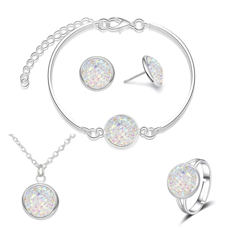 Alt Tag: silver plated rhinestone jewelry set for women featuring silver necklace, bracelet, stud earrings and ring with sparkling round stones