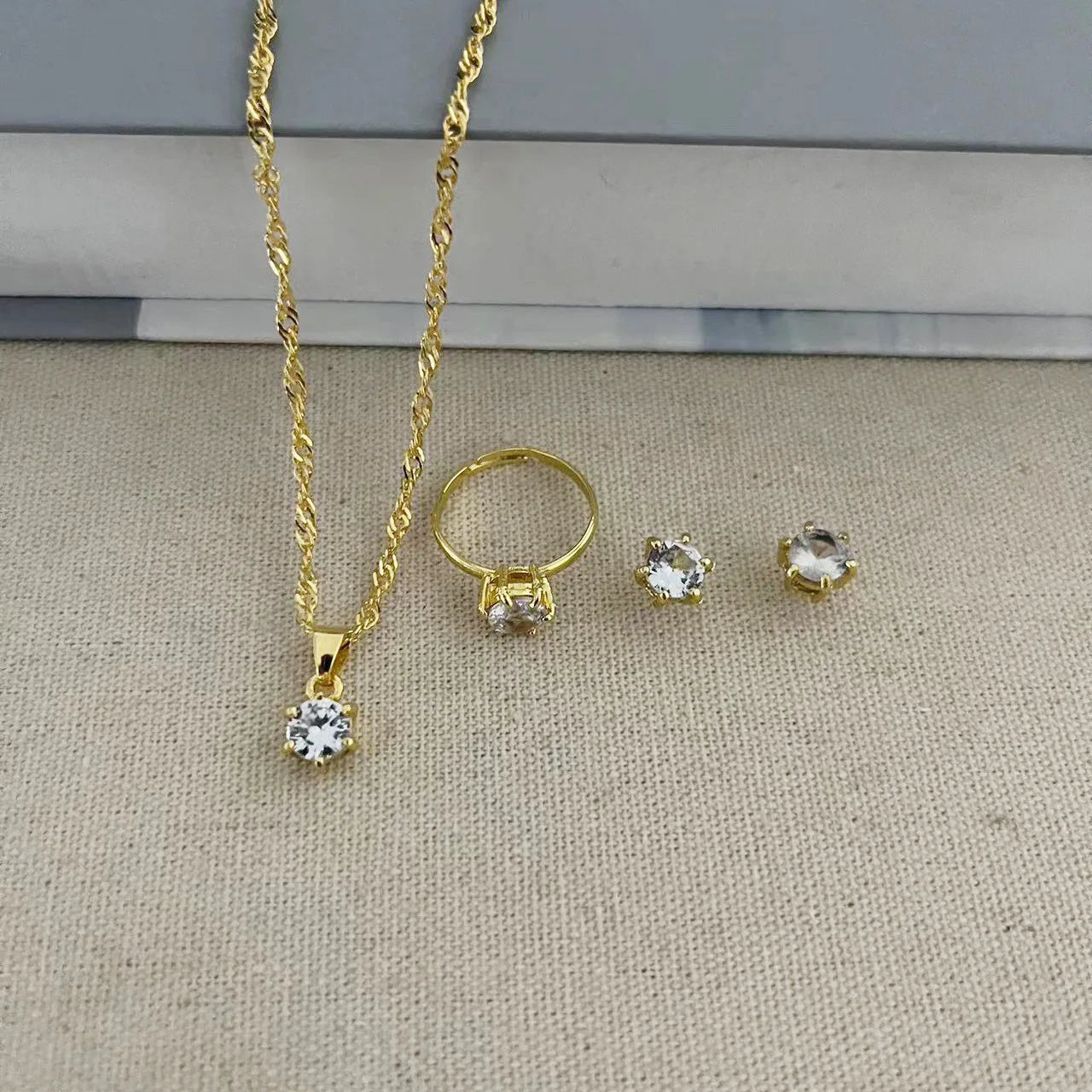 Alt Tag: 5 piece crystal jewelry set for women gold-tone necklace pendant ring and stud earrings with clear crystals