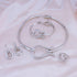 gold choker necklace jewelry set for women featuring shiny statement choker, matching bracelet, earrings and ring on pink satin