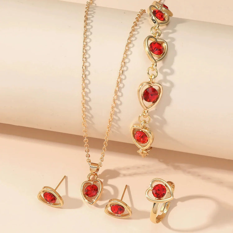Alt Tag: heart crystal jewelry set for women gold-tone necklace bracelet ring and stud earrings with red heart crystals