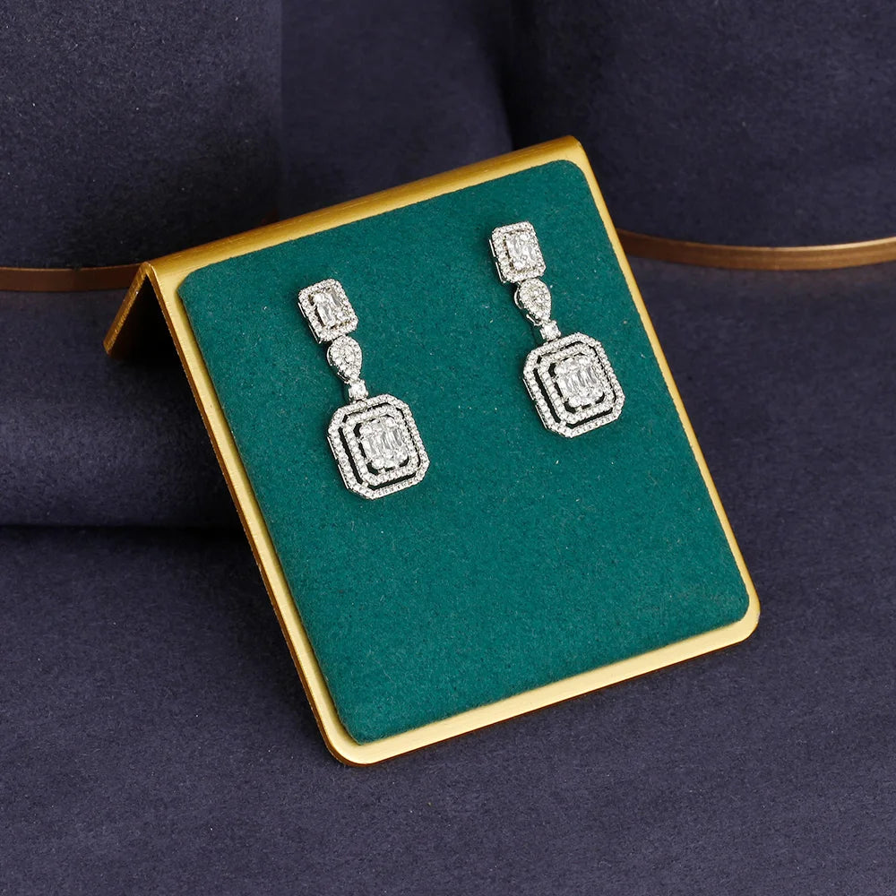Alt Tag: rhinestone crystal bridal jewelry set square drop earrings with sparkling rhinestones on green display