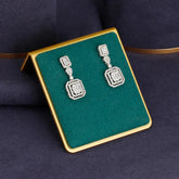 Alt Tag: rhinestone crystal bridal jewelry set square drop earrings with sparkling rhinestones on green display