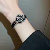 Alt Tag: crystal flower rhinestone choker necklace set black rose rhinestone bracelet on wrist close-up fashion jewelry
