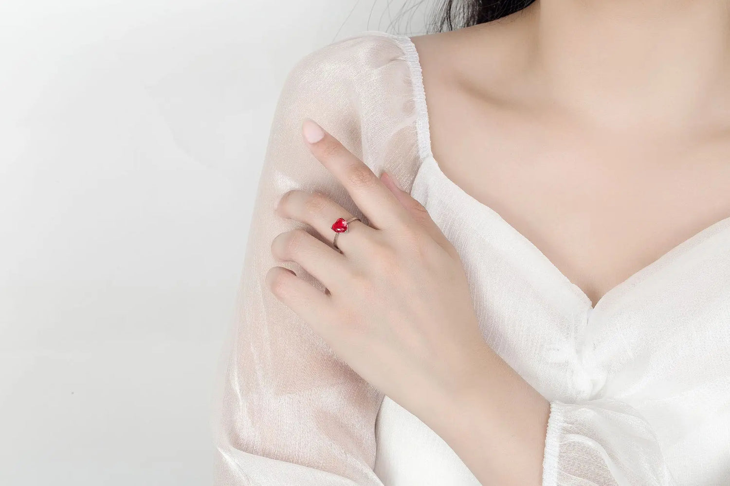 heart zircon 925 silver bridal jewelry set red heart zircon ring on bride hand in white dress close-up