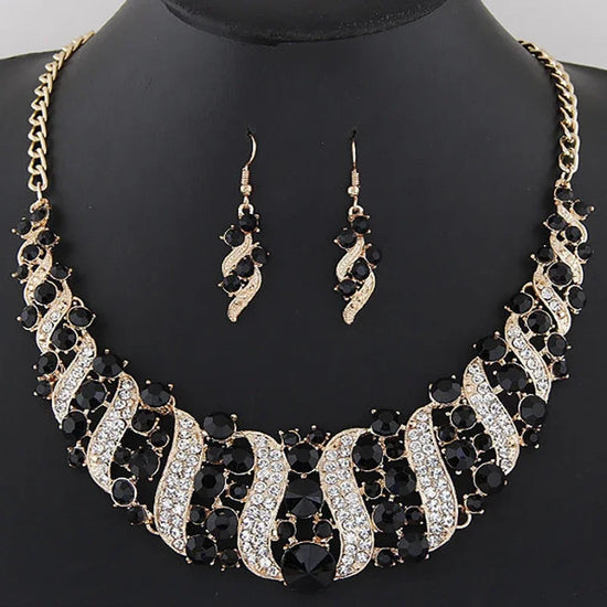 crystal bridal necklace and earrings set with rhinestone and black crystal statement necklace, matching drop earrings on display bust