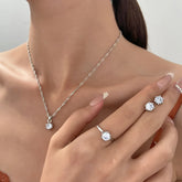Alt Tag: 5 piece crystal jewelry set for women featuring crystal pendant necklace, ring and stud earrings on model