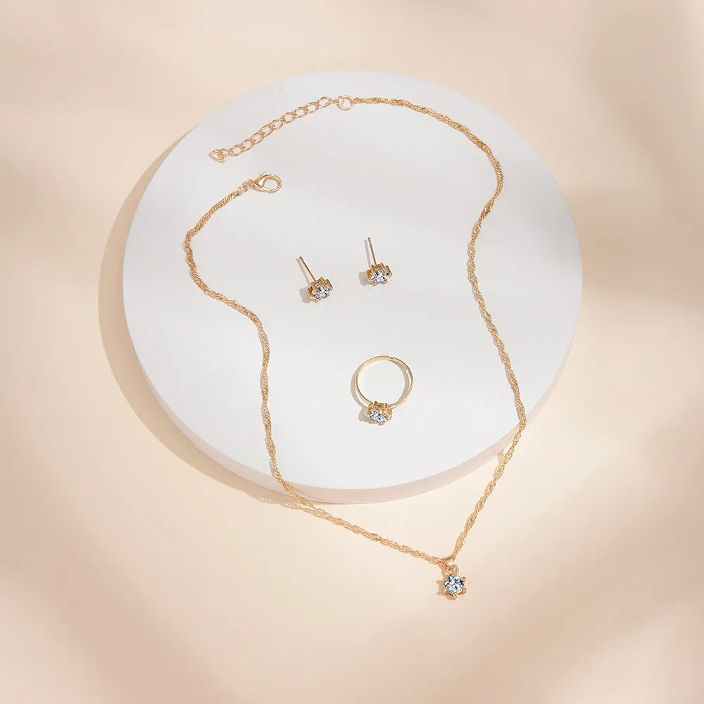Alt Tag: 5 piece crystal jewelry set for women gold-tone necklace pendant ring and stud earrings with clear crystals