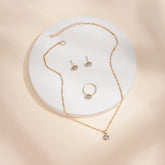 Alt Tag: 5 piece crystal jewelry set for women gold-tone necklace pendant ring and stud earrings with clear crystals