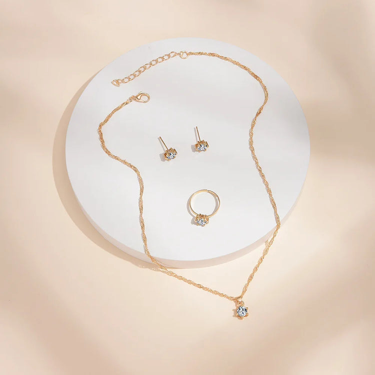 Alt Tag: 5 piece crystal jewelry set for women gold-tone necklace pendant ring and stud earrings with clear crystals