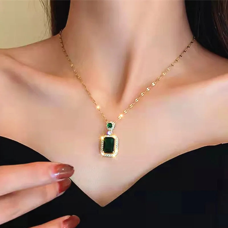 titanium steel green zircon necklace for women gold chain with green rectangular pendant and halo, worn on neck close-up
