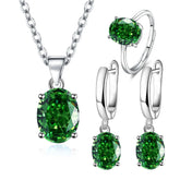 Alt Tag: 925 sterling silver bridal jewelry set with green gemstone pendant necklace, ring and drop earrings on white background